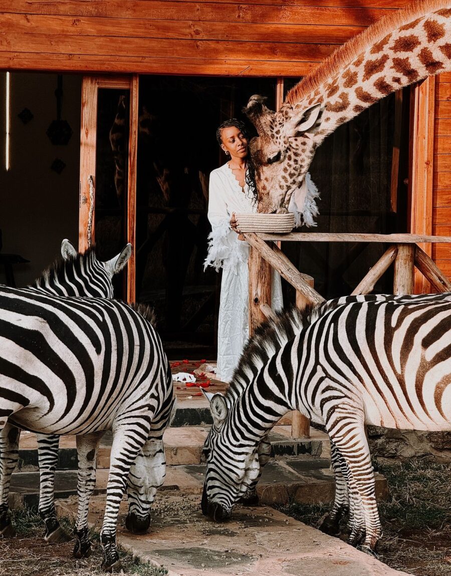Woman feeding a girafee